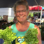 Photo of Ellen Polishuk holding some vegetables.