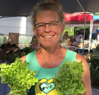 Photo of Ellen Polishuk holding some vegetables.