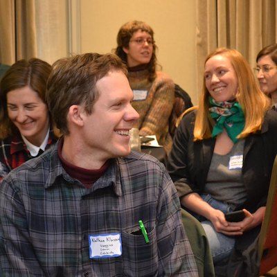 Smiling farmer researchers chat among themselves during the EFAO conference