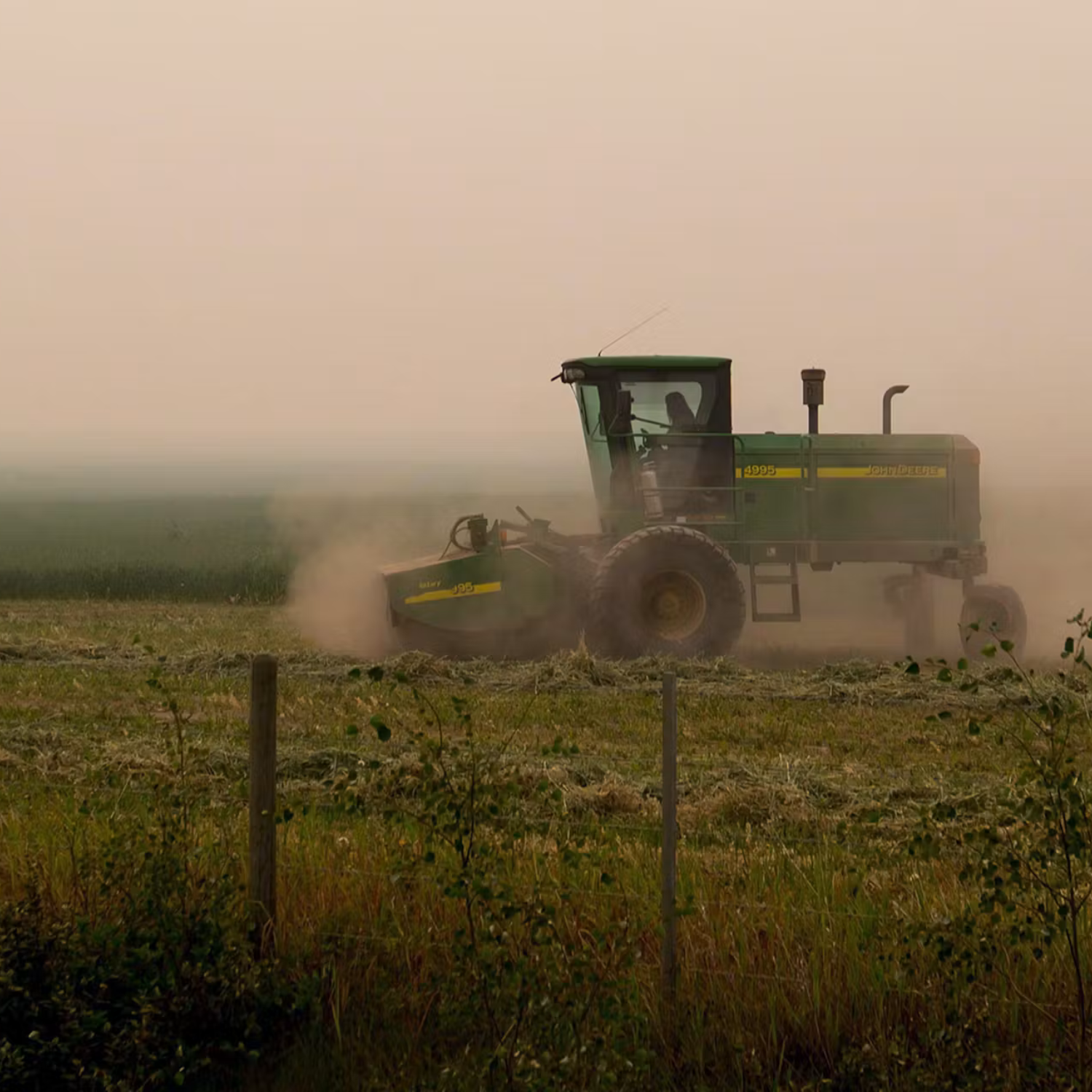 Tractor on a farm with the smoky sky