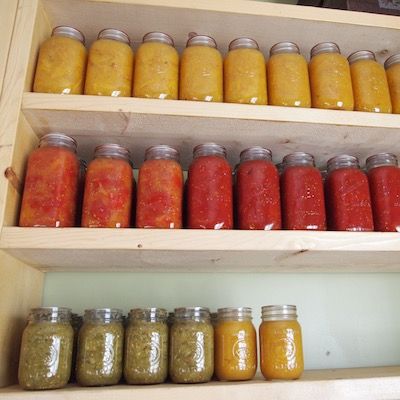 Jars of preserves on a wooden shelf